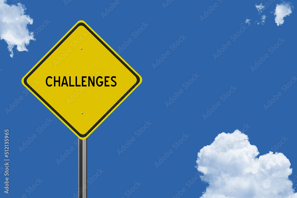 The word Challenge on a yellow road sign on a blue sky background. Inspirational concept for success in life. The word Challenge on a yellow road sign on a blue sky background. Inspirational concept for success in life.