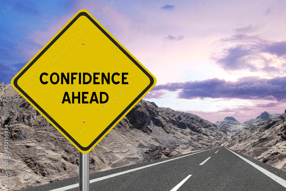 Yellow highway sign with the word Confidence and a metaphoric road leading to future success.