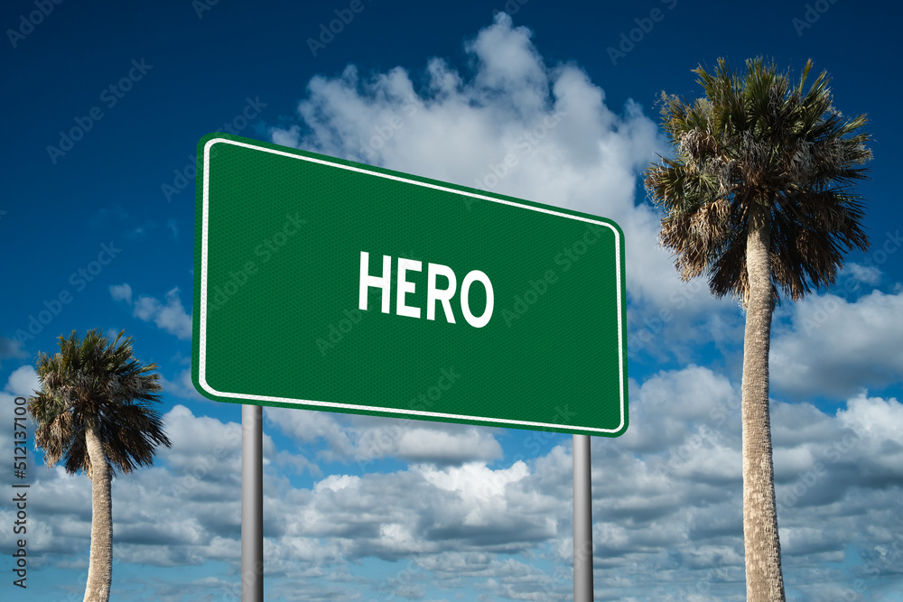 Fototapeta premium Highway sign with the word Hero on a beautiful blue sky background with palm trees. Motivational concept for finding what we want on the journey of life.