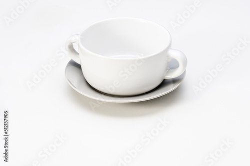 Simple white ceramic soup bowl with saucer, isolated on white