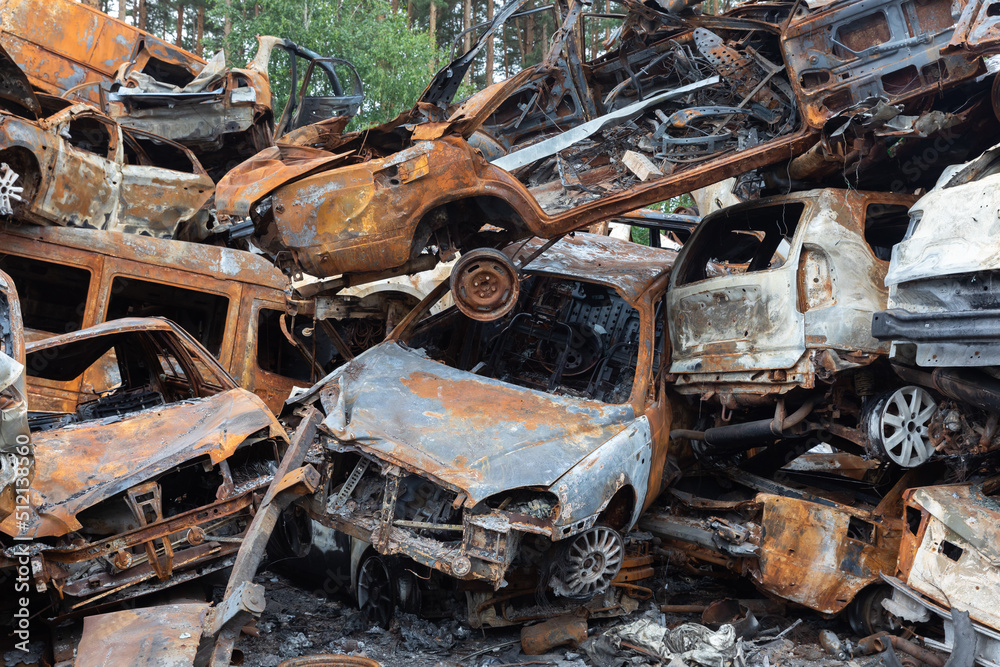 War in Ukraine. Car graveyard in Irpin. Shot cars of civilians.