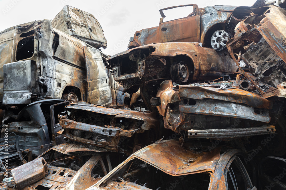 Fototapeta premium War in Ukraine. Car graveyard in Irpin. Shot cars of civilians.