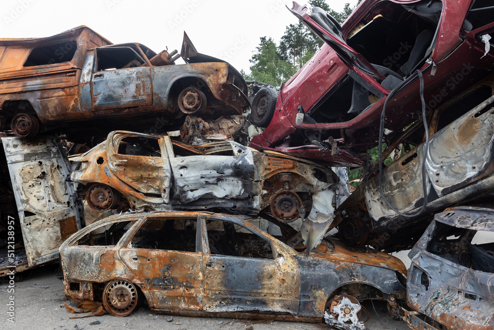 War in Ukraine. Car graveyard in Irpin. Shot cars of civilians.