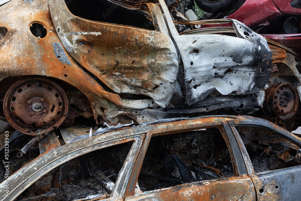 War in Ukraine. Car graveyard in Irpin. Shot cars of civilians. War in Ukraine. Car graveyard in Irpin. Shot cars of civilians.