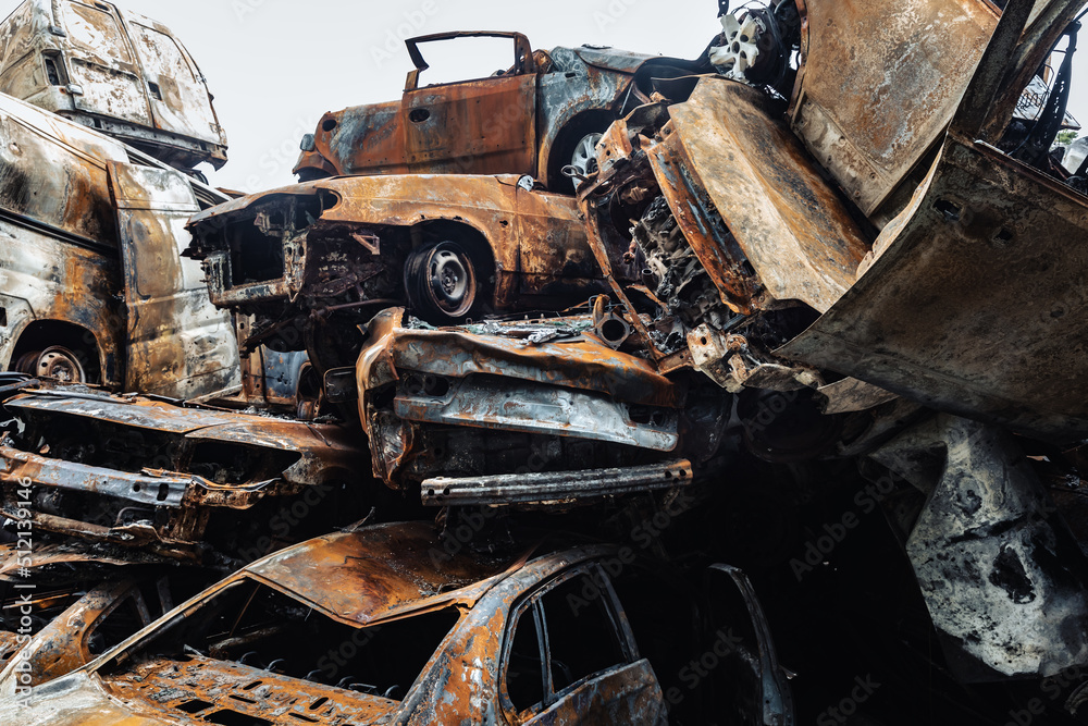 Fototapeta premium War in Ukraine. Car graveyard in Irpin. Shot cars of civilians.