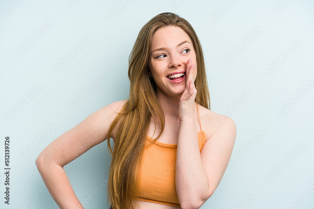 Young caucasian woman isolated on blue background shouting excited to front. Young caucasian woman isolated on blue background shouting excited to front.