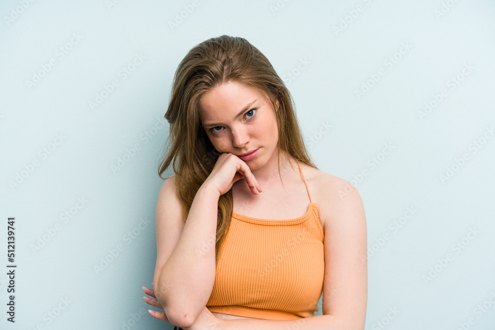 Young caucasian woman isolated on blue background tired of a repetitive task. Young caucasian woman isolated on blue background tired of a repetitive task.