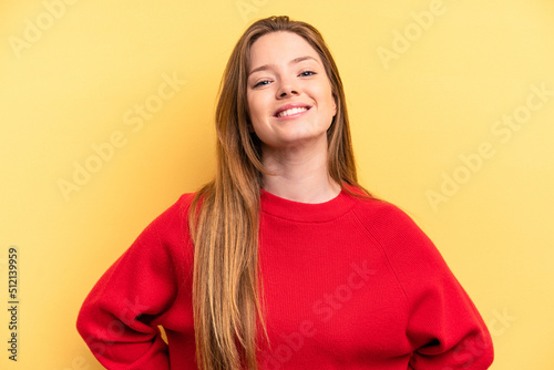 Young caucasian woman isolated on yellow background happy, smiling and cheerful.