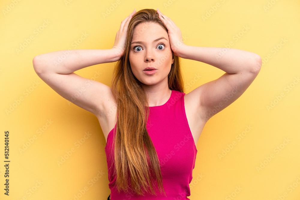 Young caucasian woman isolated on yellow background being shocked, she has remembered important meeting.