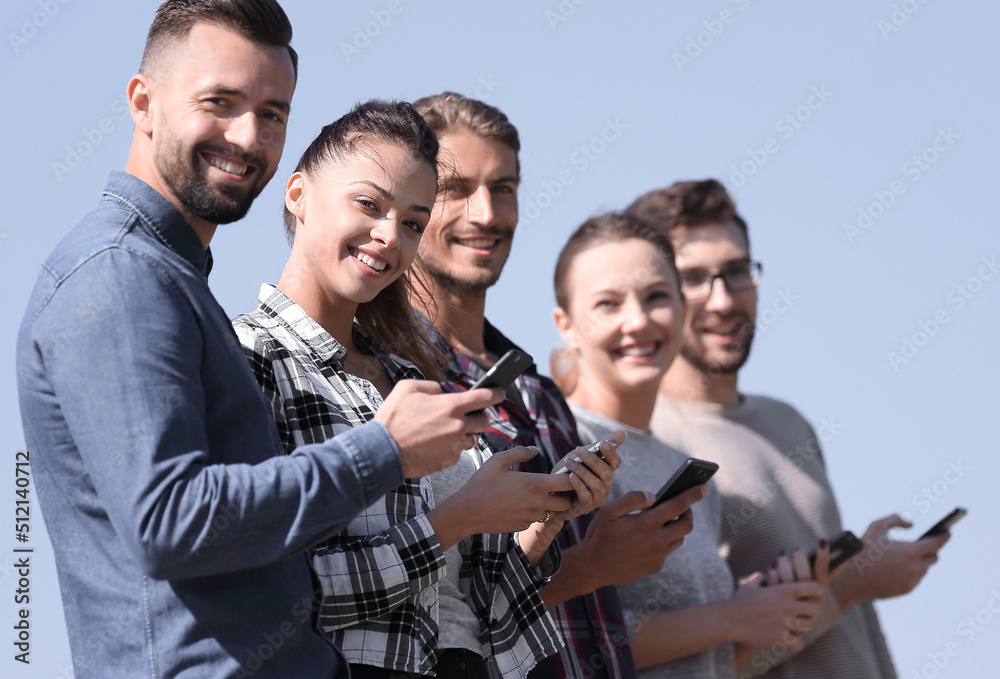 group of young people with modern smartphones. group of young people with modern smartphones.