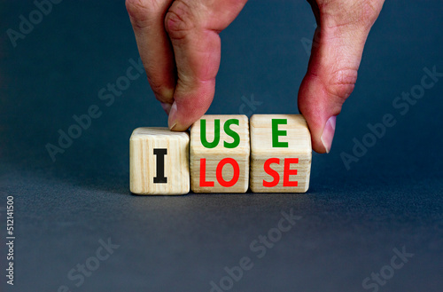 I use or lose it symbol. Concept words I use and I lose on wooden cubes. Businessman hand. Beautiful grey table grey background. Business and i use or lose it concept. Copy space.