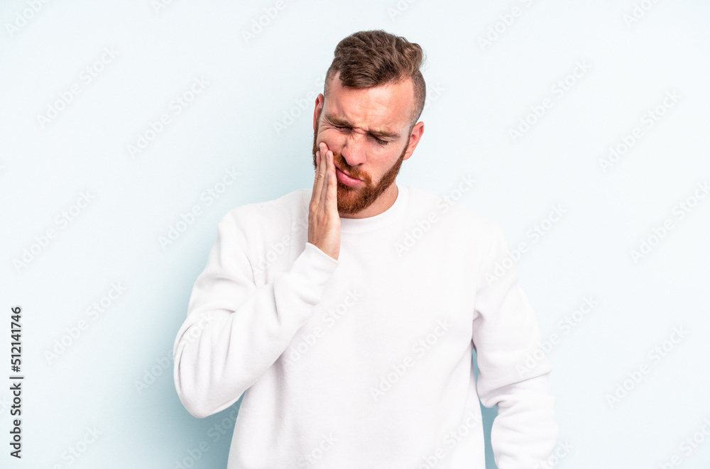 Young caucasian man isolated on blue background having a strong teeth pain, molar ache. Young caucasian man isolated on blue background having a strong teeth pain, molar ache.