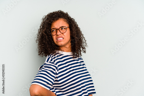 Young Brazilian woman isolated on blue background suffering a back pain.