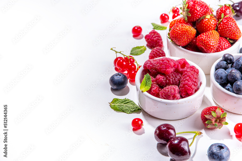 Summer vitamin food concept, set of various berries blueberry strawberry currant, flat lay on white background top view copy space