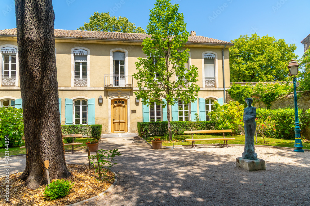 A picturesque courtyard with statue outside a public building in the historic center of Saint-Remy de Provence in the Cote d'Azur Provence region of Southern France.