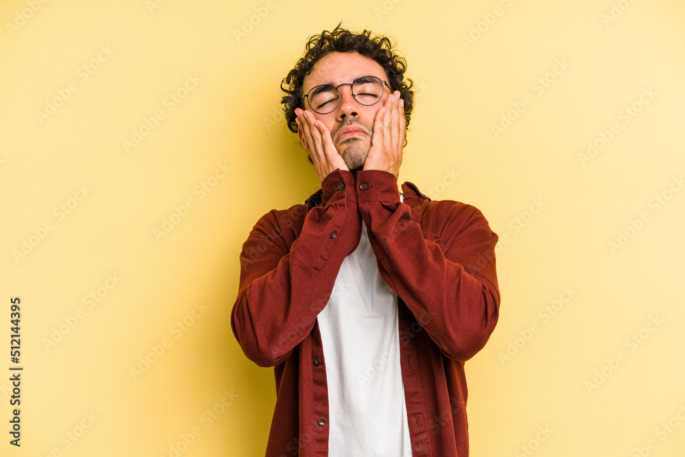 Young caucasian man isolated on yellow background whining and crying disconsolately. Young caucasian man isolated on yellow background whining and crying disconsolately.
