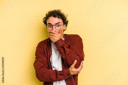 Young caucasian man isolated on yellow background scared and afraid.