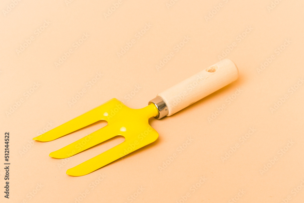 Garden tools isolated on beige background Garden tools isolated on beige background