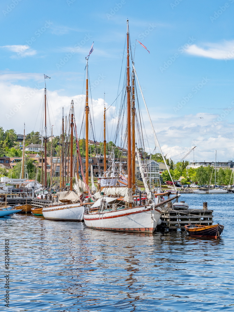 Wooden sailboats tied to the dock in Fredrikstad, Norway.