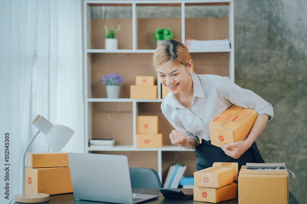 Looking camera, Startup small business SME, Entrepreneur owner using tablet taking receive and checking online purchase shopping order to preparing pack product box Looking camera, Startup small business SME, Entrepreneur owner using tablet taking receive and checking online purchase shopping order to preparing pack product box