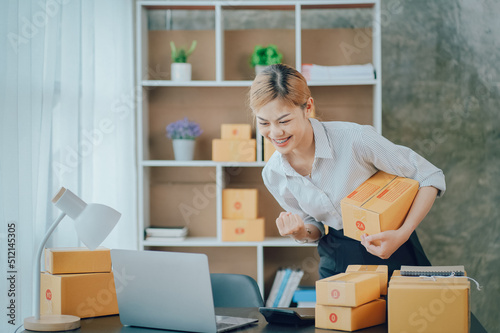 Looking camera, Startup small business SME, Entrepreneur owner using tablet taking receive and checking online purchase shopping order to preparing pack product box