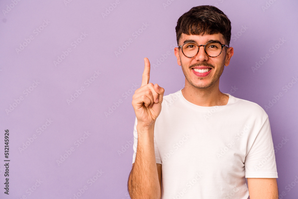 Young caucasian man isolated on purple background showing number one with finger. Young caucasian man isolated on purple background showing number one with finger.