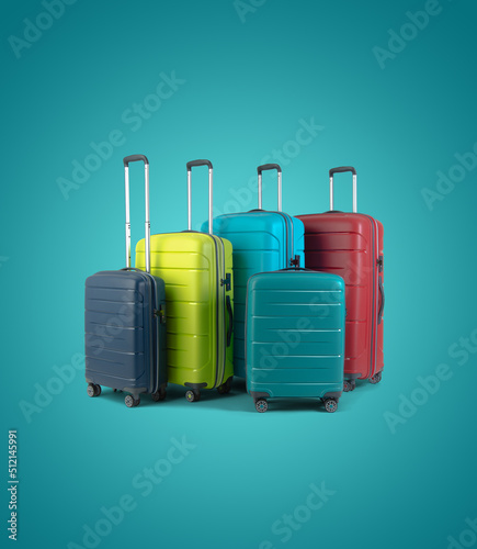 Set of different colored stylish suitcases for travel on blue background.
