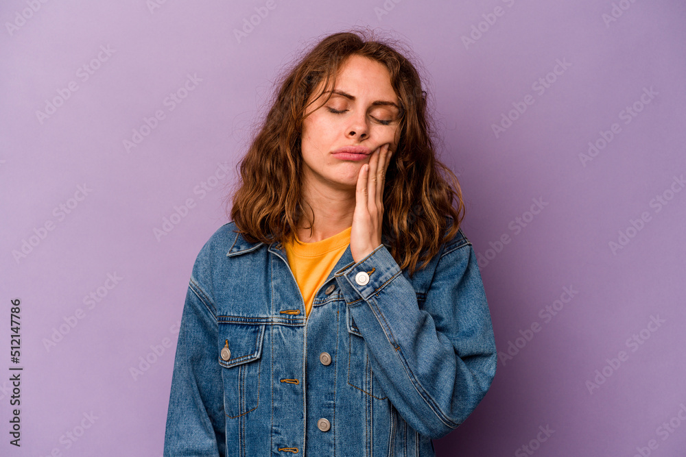 Young caucasian woman isolated on purple background having a strong teeth pain, molar ache. Young caucasian woman isolated on purple background having a strong teeth pain, molar ache.