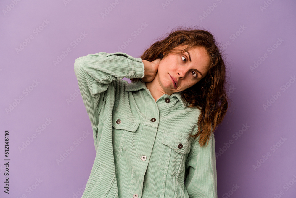 Young caucasian woman isolated on purple background suffering neck pain due to sedentary lifestyle.