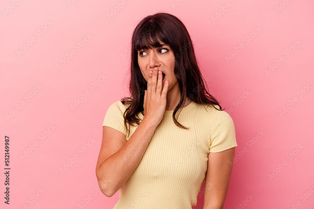 Young caucasian woman isolated on pink background yawning showing a tired gesture covering mouth with hand. Young caucasian woman isolated on pink background yawning showing a tired gesture covering mouth with hand.