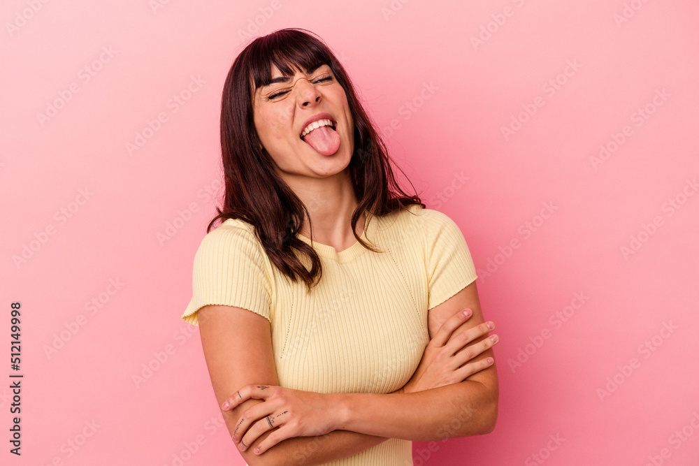 Young caucasian woman isolated on pink background funny and friendly sticking out tongue. Young caucasian woman isolated on pink background funny and friendly sticking out tongue.