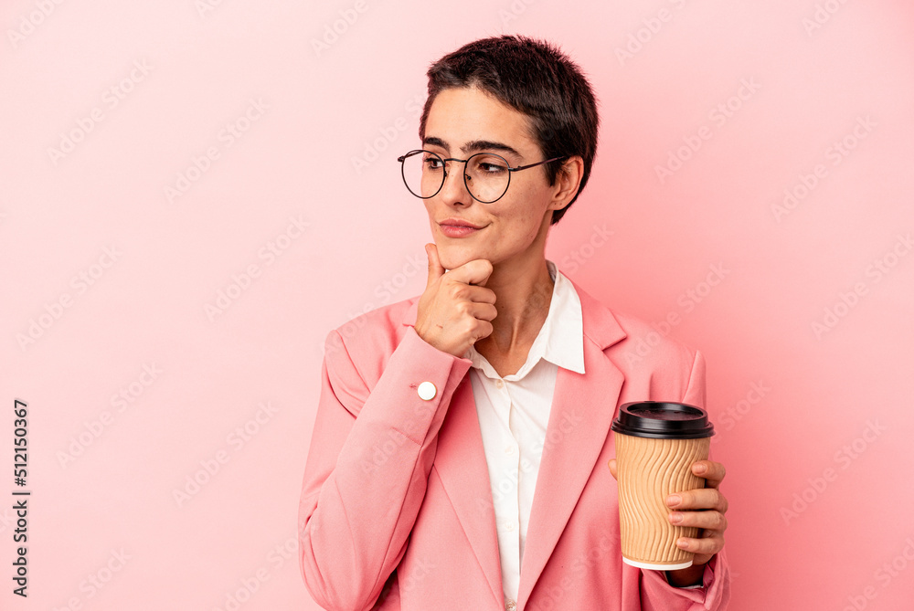 Young caucasian business woman holding a takeaway coffee isolated on pink background looking sideways with doubtful and skeptical expression. Young caucasian business woman holding a takeaway coffee isolated on pink background looking sideways with doubtful and skeptical expression.