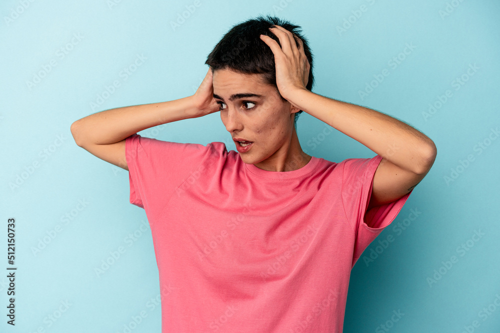 Young caucasian woman isolated on blue background screaming, very excited, passionate, satisfied with something. Young caucasian woman isolated on blue background screaming, very excited, passionate, satisfied with something.