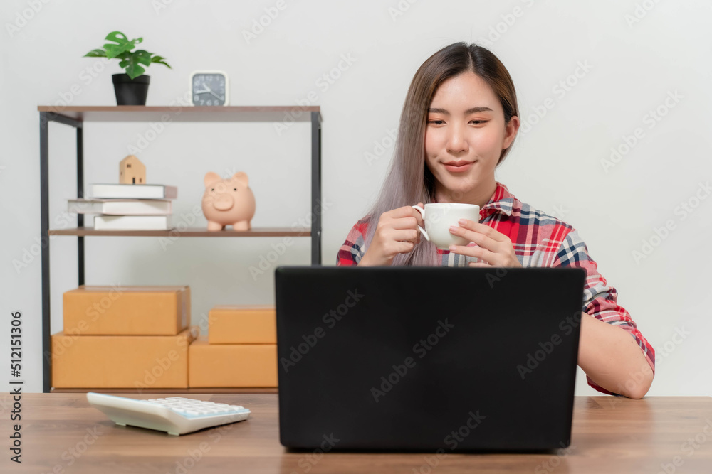 A young businesswoman is very happy after checking her email through her laptop.