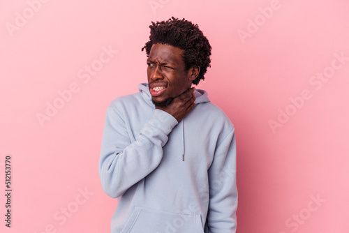 Young african american man isolated on pink background touching back of head, thinking and making a choice.
