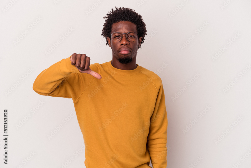 Young african american man isolated on white background showing a dislike gesture, thumbs down. Disagreement concept. Young african american man isolated on white background showing a dislike gesture, thumbs down. Disagreement concept.