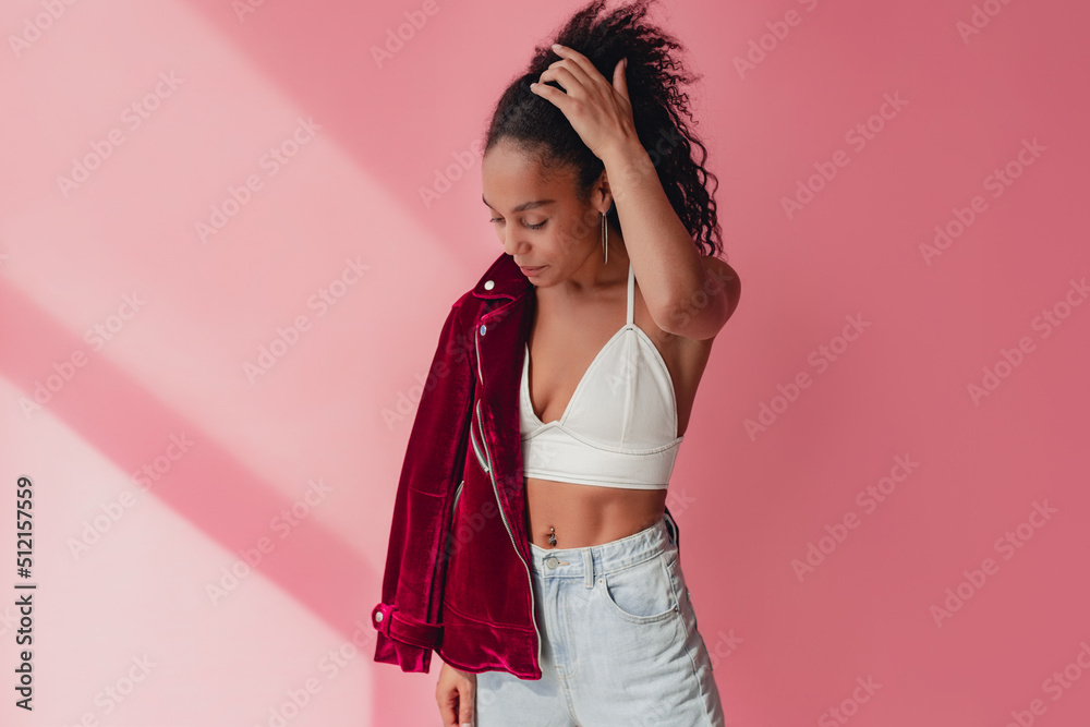 attractive black african american woman in stylish outfit on pink background attractive black african american woman in stylish outfit on pink background