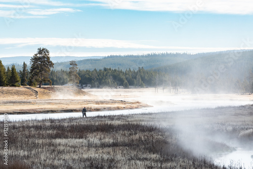Early morning mist on the Madison River, Yellowstone National Park with fisherman