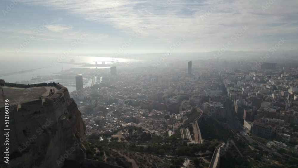 Flyover from Santa Barbara Fortress over Alicante Cityscape, During Morning haze, Spain Flyover from Santa Barbara Fortress over Alicante Cityscape, During Morning haze, Spain