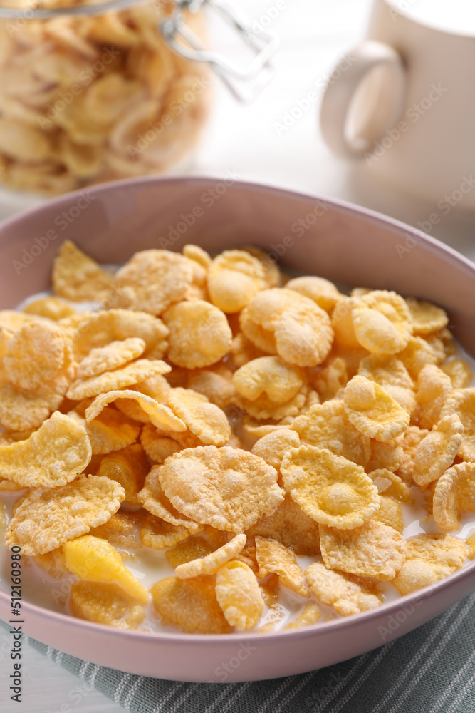 Tasty cornflakes with milk in bowl on table, closeup Tasty cornflakes with milk in bowl on table, closeup
