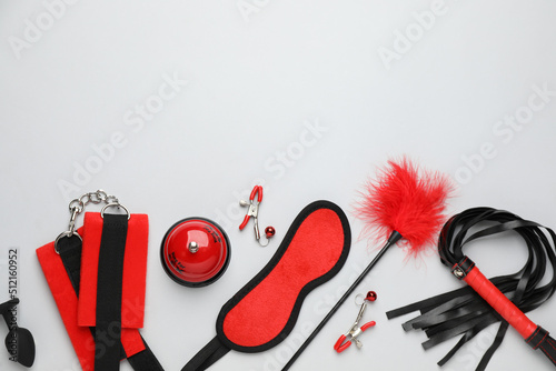 Sex toys and accessories on white background, flat lay. Space for text © New Africa