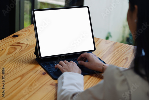 A woman using a tablet with a blank white screen. The blank space on the white screen can be used to write a message or place an image