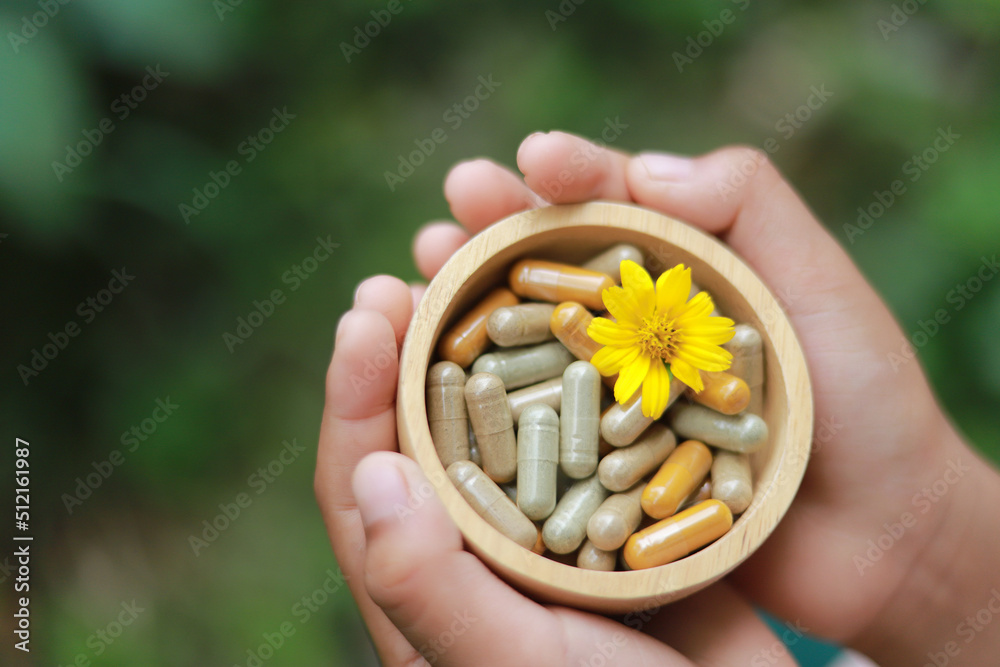 hand hold herbal medicine in bowl for healthy eating. SELECTIVE FOCUS. hand hold herbal medicine in bowl for healthy eating. SELECTIVE FOCUS.