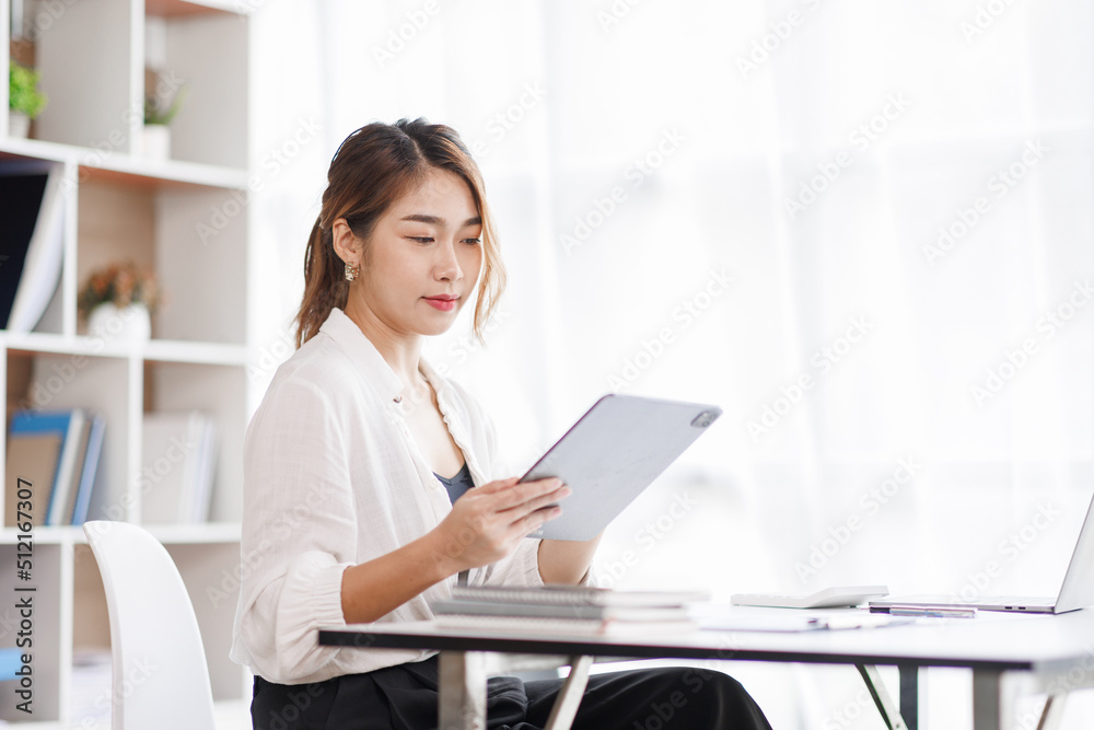 Cropped shot of Asian woman hand working on laptop computer while sitting at the table in office room, vertical view. Cropped shot of Asian woman hand working on laptop computer while sitting at the table in office room, vertical view.