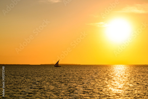 Traditional sail boat dhow at the Indian ocean when sunset photo