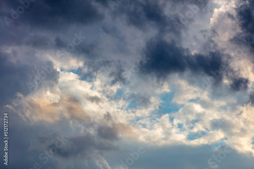 Cloud on blue sky background. Cloudscape grey and orange shade. Twilight light color the cloudy sky © Rawf8