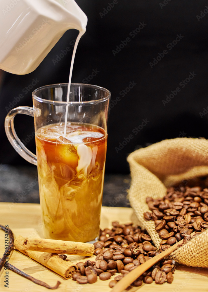 Lets try something different. Shot of coffee beans and a cup of cinnamon and vanilla coffee. Lets try something different. Shot of coffee beans and a cup of cinnamon and vanilla coffee.