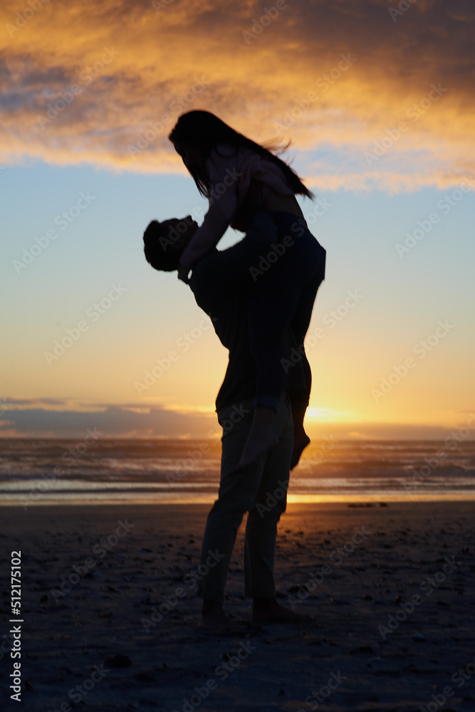 You have my heart. Silhouette shot of a young couple on the beach.
