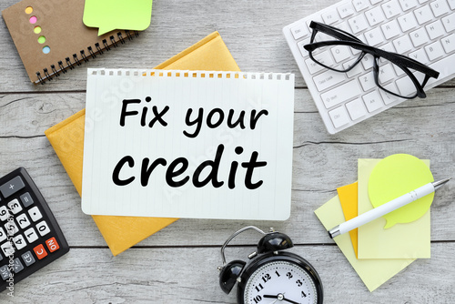 Fix your credit poster isolated on a wooden background