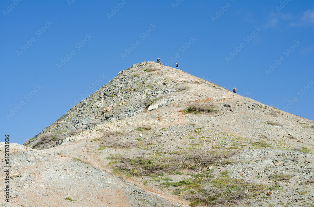 Fototapeta premium Pico Pilon de Azucar, people climbing the mountain. Colombian La Guajira desert. Landscape in the desert.